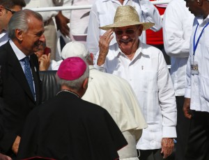 Pope Francis is greeted by Cuba's President Raul Castro as he arrives to lead a mass for Catholic faithful in the city of Holguin